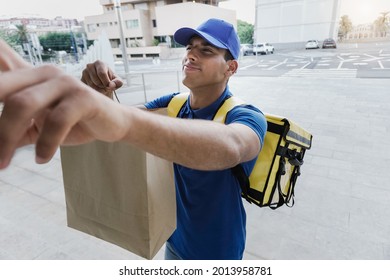 Courier African Man Doing Fast Food Delivery With Thermal Backpack Ringing The Doorbell - Focus On Face