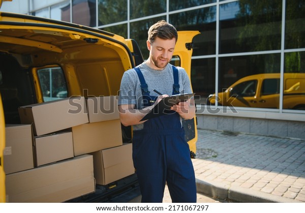 The courier brought the\
delivery of the box to the client. Courier service employee in\
uniform