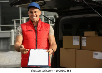 Courier with clipboard near car full of packages outdoors - Powered by Shutterstock