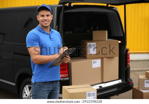 Courier with\
clipboard near delivery van\
outdoors
