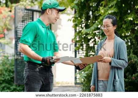 Courier delivering important documents and contracts to woman
