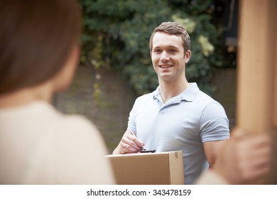 Courier Delivering Package To Domestic House