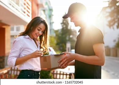 Courier Delivering Package To Woman, Client Signing Document