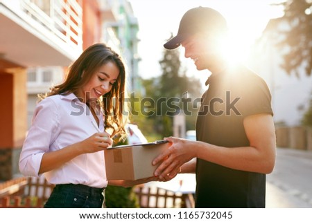 Courier Delivering Package To Woman, Client Signing Document