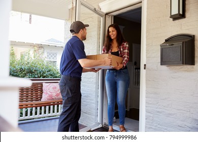 Courier Delivering Package To Woman At Home