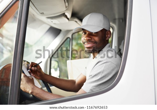 Courier
Delivery. Black Man Driver Driving Delivery Car
