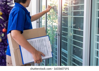 courier delivery man checking or holding cardboard parcel package to deliver to client for accepting a delivery of boxes - Shutterstock ID 1633607191