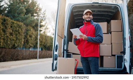 Courier with digital tablet delivering package. Mailman in front the van. High quality photo - Powered by Shutterstock