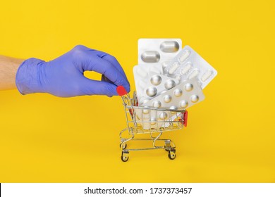 Courier In Gloves Deliver Shopping Cart With Medicine Pills Isolated. Online Order From Pharmacy Or Drugstore. Safe Contact Less Courier Delivery Medicine. Pharmaceutical Business. Copy Space Mock Up