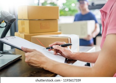 Courier hands Business woman work at home office checking parcel package box by keying machine track tools before ship and documents data.