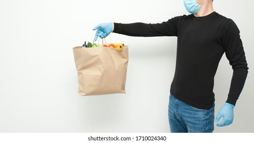 The Courier Is Holding The Paper Bag From Grocery Store In Hand Wearing The Latex Gloves