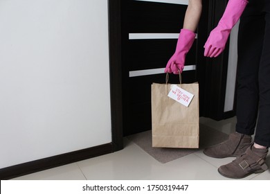 The Courier Left Paper Bag On Doorstep. Concept Of Contactless Delivery.