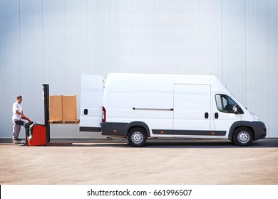Courier Is Loading The Van With Parcels