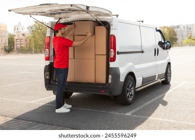 Courier man loading cardboard boxes to van, preparing for delivering postal parcel, outdoors shot - Powered by Shutterstock