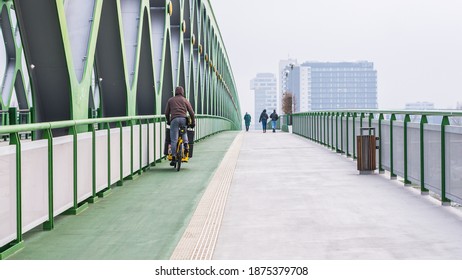 Courier On Bicycle On The New Bridge In Bratislava Distributes Food