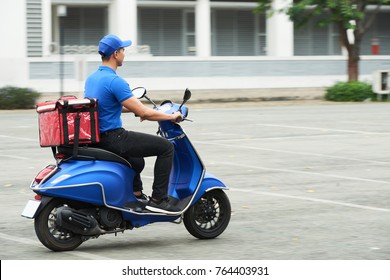 Courier on the scooter delivering food