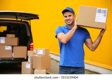 Courier with parcel near delivery van outdoors. Space for text