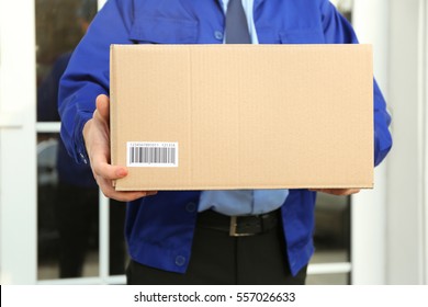 Courier With Parcel On Doorstep, Closeup