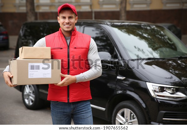 Courier with\
parcels near delivery van\
outdoors