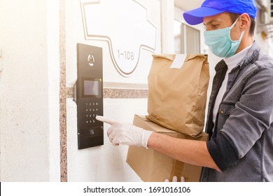 Courier in protective mask and medical gloves delivers takeaway food. Delivery service under quarantine, disease outbreak, coronavirus covid-19 pandemic conditions.