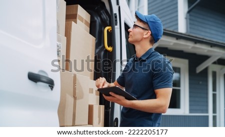 Courier Using Tablet Computer Next to Open Delivery Van Side Door with Cardboard Parcels. Mailman Delivering the Package to a Homeowner.