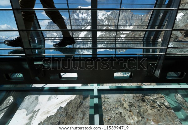 COURMAYEUR, ITALY - AUGUST\
2, 2018: People enjoying the panoramic window called Skywow,\
interior of Punta Helbronner, view of Monte Bianco (Mont Blanc)\
massif, Alps of\
Italy.