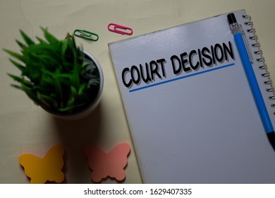 Court Decision Write On A Book Isolated On Office Desk.