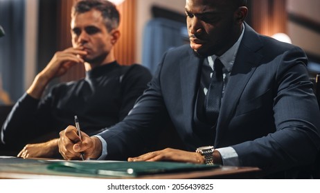 Court Of Justice And Law Trial: Male Public Defender Writes Down Arguments For Defence Strategy. African American Attorney Lawyer Fight For Freedom Of His Client With Supporting Evidence.