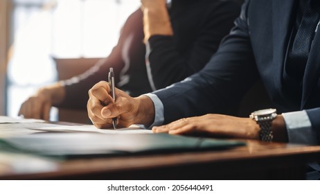 Court of Justice and Law Trial: Male Barrister Writes Down Arguments for Defence Strategy. African American Attorney Lawyer Fight for Freedom of His Client with Supporting Evidence. Close Up. - Shutterstock ID 2056440491