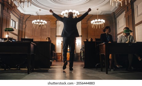 Court of Justice and Law Trial: Male Public Defender Wins the Case, Slowly Goes Away with Raised Hands. Successful African American Attorney Lawyer Serves Justice Once Again. Barrister's Work is Done. - Shutterstock ID 2056444883