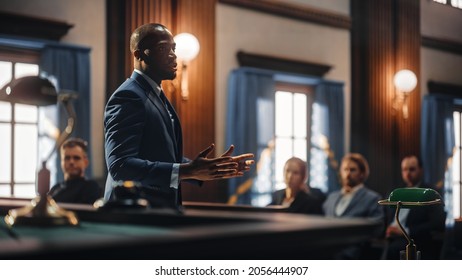 Court of Justice and Law Trial: Male Public Defender Presenting Case, Making Passionate Speech to Judge, Jury. African American Attorney Lawyer Protecting Client's Innocents with Supporting Argument.
