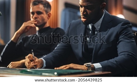 Court of Justice and Law Trial: Male Public Defender Writes Down Arguments for Defence Strategy. African American Attorney Lawyer Fight for Freedom of His Client with Supporting Evidence.