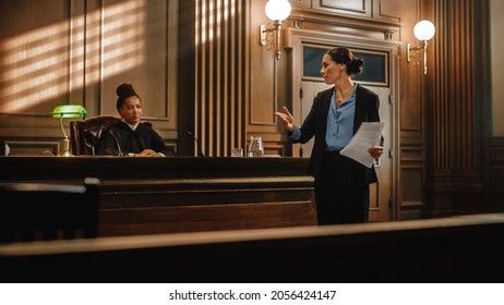 Court Of Justice And Law Trial: Successful Female Public Defender Presenting The Case, Making Passionate Speech To Judge, Jury. Attorney Lawyer Protecting Client With Closing Not Guilty Arguments.