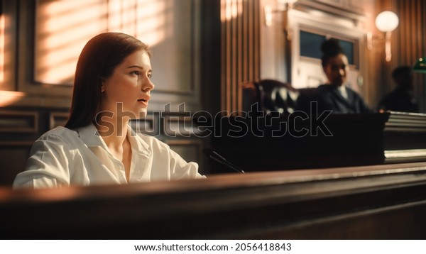 Court of Law and Justice Trial: Portrait of\
Beautiful Female Witness Giving Evidence to Prosecutor and Defence\
Counsel, Judge and Jury Listening. Dramatic Speech of Empowered\
Victim against Crime.