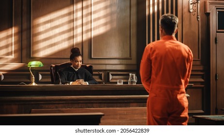 Court of Law and Justice Trial Proceedings: Law Offender in Orange Jumpsuit is Questioned and Giving Testimony to Judge, Jury. Criminal Denying Charges, Pleading, Inmate Denied Parole. - Shutterstock ID 2056422839