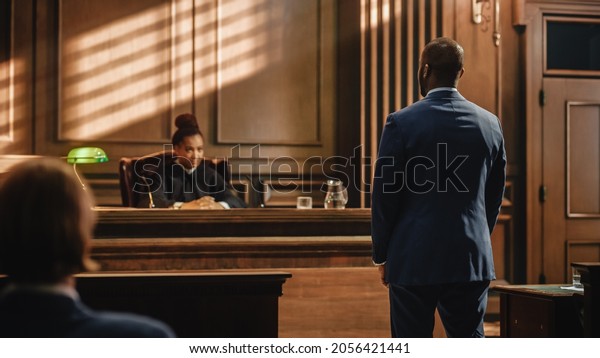 Court\
of Law and Justice Trial Proceedings: Male Law Offender is\
Questioned and Giving Testimony to Judge, Jury. Criminal Denying\
Charges, Pleading, Judge Accuses Guilty\
Defendant.