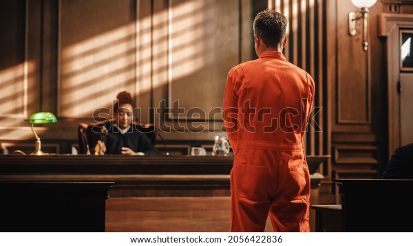 Court of Law and Justice Trial Proceedings: Law\
Offender in Orange Jumpsuit is Questioned and Giving Testimony to\
Judge, Jury. Criminal Denying Charges, Pleading, Inmate Denied\
Parole.