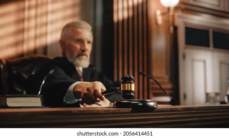 Court of Law and Justice Trial Session: Imparcial Honorable Judge Pronouncing Sentence, striking Gavel. Focus on Mallet, Hammer. Cinematic Shot of Dramatic Not Guilty Verdict.
