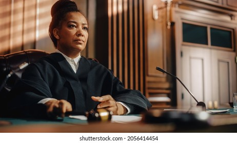 Court of Law Trial in Session: Portrait of Honorable Female Judge Reading Decision. Presiding Justice Pronouncing Sentence. Not Guilty Verdict Judgment.