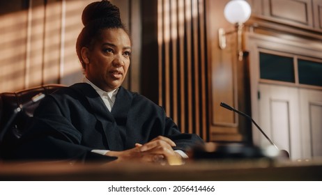 Court of Law Trial in Session: Portrait of Honorable Female Judge Reading Decision. Presiding Justice Pronouncing Sentence. Guilty, Not Guilty Verdict Judgment. Medium Portrait Shot