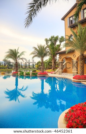 An court of villa with an swimming pool  and  a view  looking out to the river beside during sunset.HDR shot from three pictures
