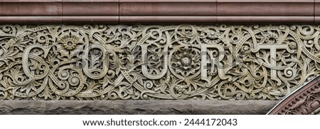 The court word is engraved in stone decoration. Colonial architectural feature or detail in Old City Hall Building (1898), Toronto, Canada