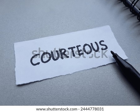 Courteous writting on table background.