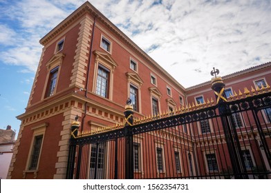 Courthouse (Palace of Justice) of Toulouse, France - The brick-building of the Court of Appeals, around the patio and flying a French flag, behind a cast iron gate closed by a chain