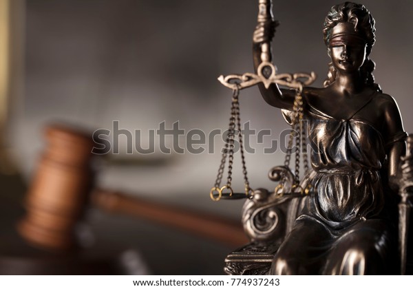 Courtroom concept. Blind justice,\
mallet of the judge. Gray stone background. Place for\
typography.