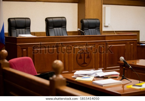 A\
courtroom in a Russian court, an empty judge\'s\
chair