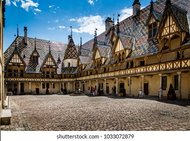 Courtyard and Burgundian tiled roof of the Hospice de Beaune taken in Beaune, Burgundy, France on 17 June 2018