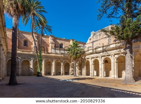 Similar – Image, Stock Photo A Mediterranean courtyard, the curved facade of a residential building and a delicate flower