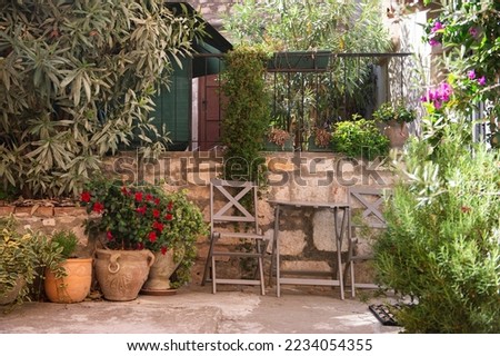 Similar – Image, Stock Photo A Mediterranean courtyard, the curved facade of a residential building and a delicate flower