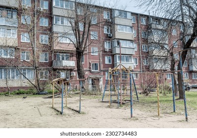 Courtyard of Khrushchyovka, common type of old low-cost apartment building in Russia and post-Soviet space since 1960s. Playground on foreground. Life in Russia. Russia, Vladivostok.
